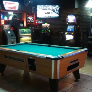 a pool table and arcade machines