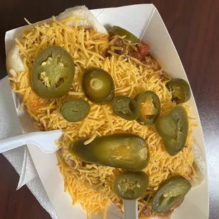 a hot dog with cheese and jalapenos