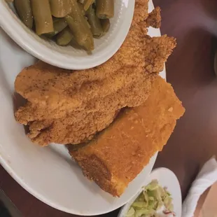 a plate of fried fish and green beans