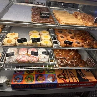 a variety of donuts in a display case