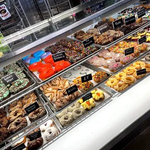 a variety of donuts in a display case