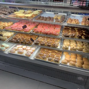 a variety of donuts in a display case