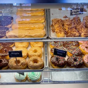 a variety of donuts in a display case