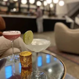 The smoothest Gin Gimlet with lime garnish and the Whiskey Smash topped with a sprig of thyme.