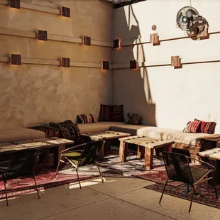 a patio area with tables and chairs
