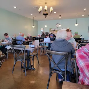 people sitting at tables in a restaurant