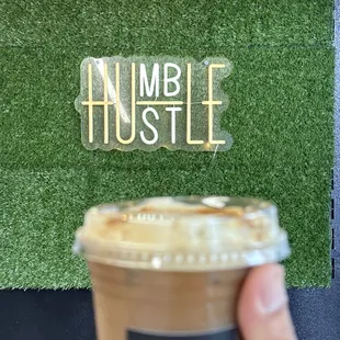 a hand holding a cup of coffee