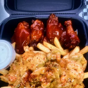 chicken wings and fries in a container