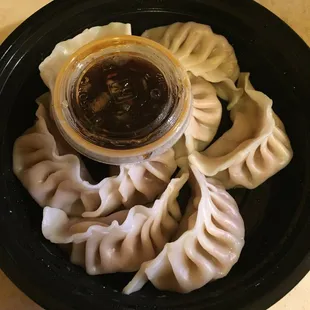 a plate of dumplings and sauce