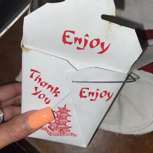a hand holding an envelope with a thank you written on it