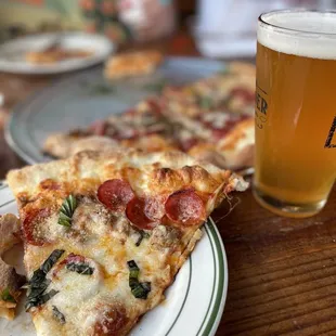 a slice of pizza and a glass of beer