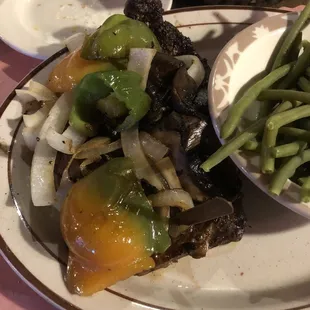 There's a big steak hiding under those veggies!