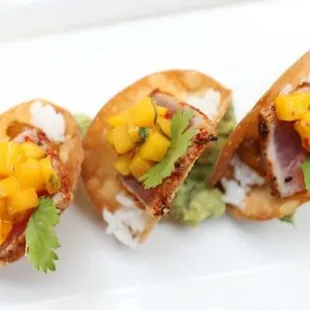 three pieces of sushi on a white plate