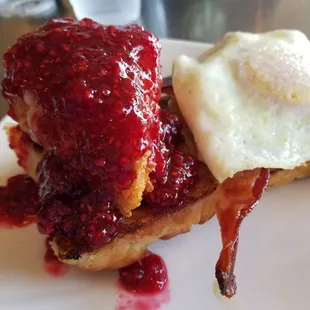 Biscuit with fried brie cheese, raspberry jam bacon and an over easy egg. One of the best things I ate on vacation.