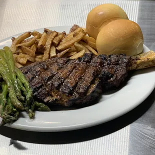 a steak, asparagus, and a burger