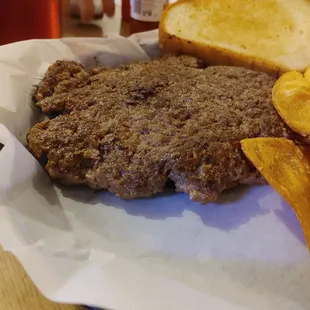 This is a hamburger steak. It can come with onions and peppers. My husband likes it plain. Look at the size of that hamburger steak y'all.
