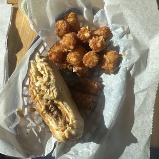 Burger with coleslaw and tater tots