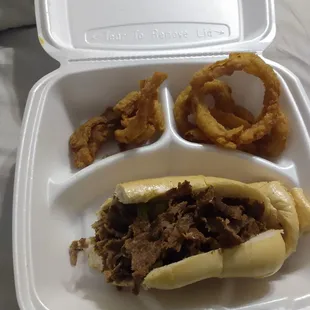 a tray with a sandwich and onion rings