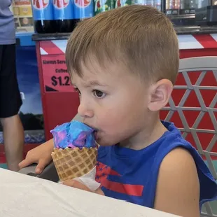 Cotton candy/ orange swirl in a waffle cone.