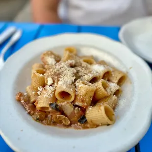 a plate of pasta on a blue table