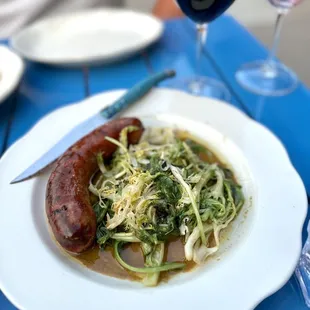 a plate of food and a glass of wine