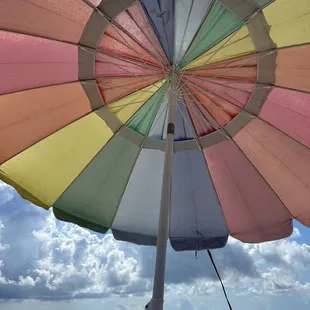 a colorful umbrella on the beach