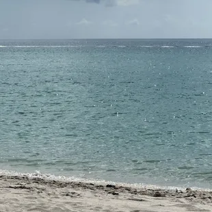 a person sitting on a bench on the beach