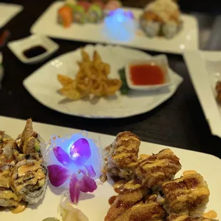 a plate of sushi and a plate of french fries