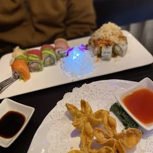 a plate of food and a bowl of sauce