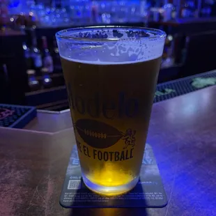 a pint of beer on a coaster