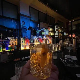 a person holding a glass of beer