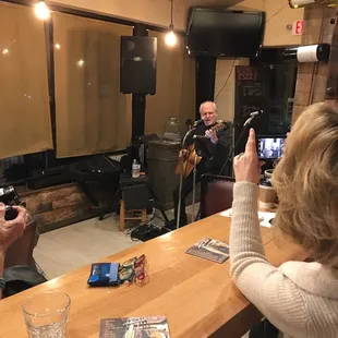 a group of people sitting at a bar
