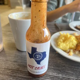 a bottle of hot sauce on a table