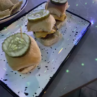 a plate of sliders and chips