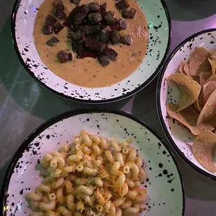 three bowls of food on a table