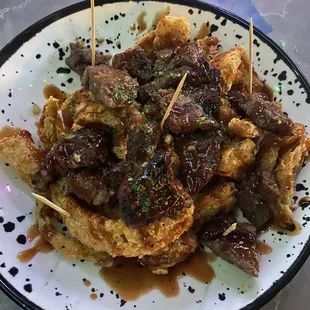 a plate of food with toothpicks