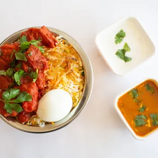 a bowl of dum biryani and a bowl of soup