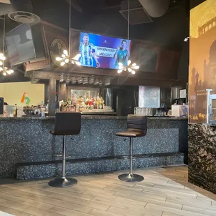 a bar with a television on the wall