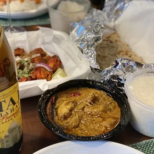 a plate of food and a bottle of beer