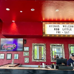 a man and woman sitting at the bar