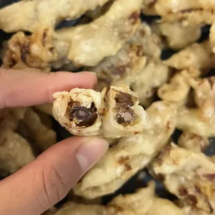 a person holding a piece of food