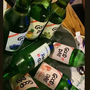 a pile of green beer bottles