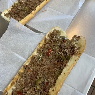 two sub sandwiches on a table