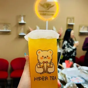 a person holding a cup of tea