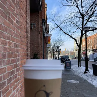 a hand holding a cup of coffee