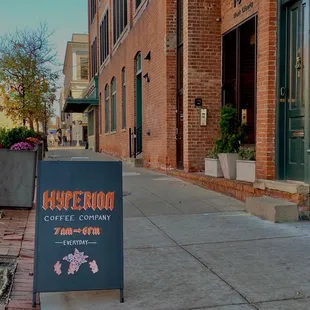 a sidewalk with a sign for hyperion coffee company