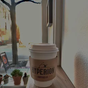 a cup of coffee on a window sill