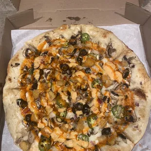 Build your own pizza with roasted garlic sauce, Buffalo chicken, olives, onions, jalapeños, mushrooms, and tomato drizzle