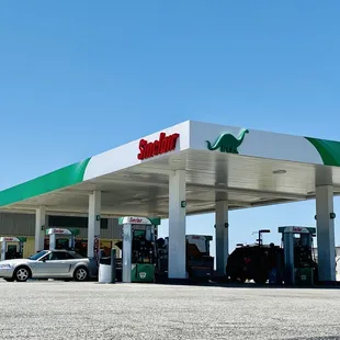 a gas station with a car parked in front of it