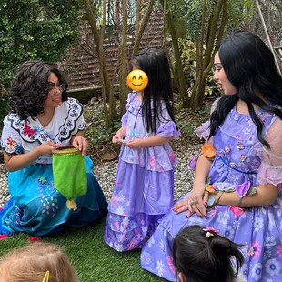 Mirabel and Isabela performing a magic trick